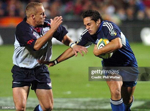 AUCKLAND, NEW ZEALAND - APRIL 09:  Blues Ben Atiga fends off Bulls Ettienne Botha in their Super 12 rugby match played at the North Harbour Stadium in Auckland, New Zealand, Friday, April 09th, 2004. The Blues won 5619.  (Photo by Phil Walter/Getty Images)