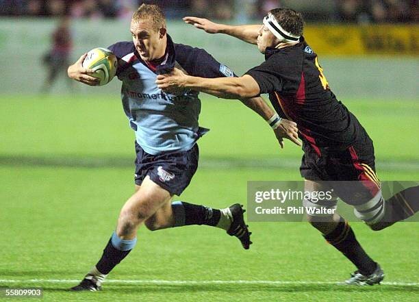 HAMILTON, NEW ZEALAND - APRIL 30:  Bulls Ettienne Botha is tackled by Chiefs captain Jono Gibbes in their Super 12 rugby match played at Waikato Stadium in Hamilton, New Zealand, Friday, April 30th, 2004.  (Photo by Phil Walter/Getty Images)